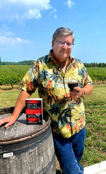 Picture of Stephen J. Kristof, Author, standing by a wine barrel in a vineyard with his book, Short Stories to Enjoy with Wine 